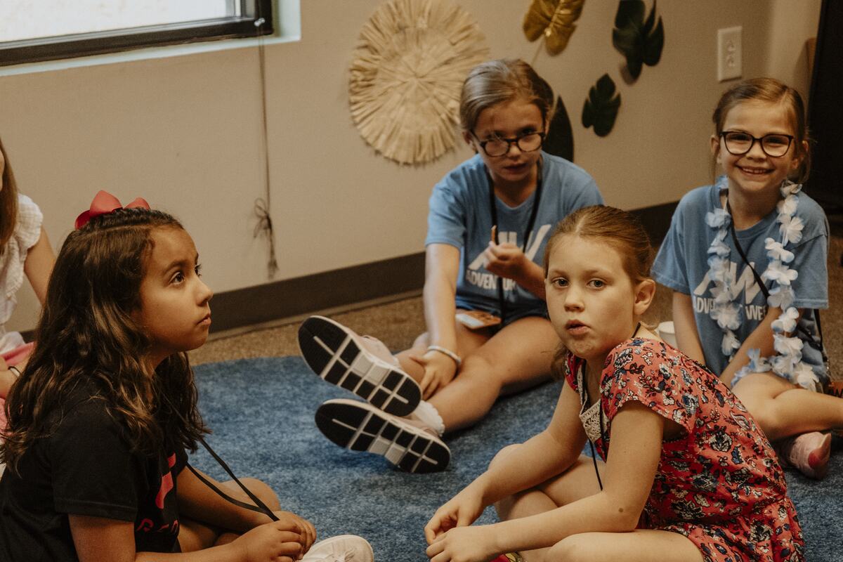 Children sitting together on the floor.