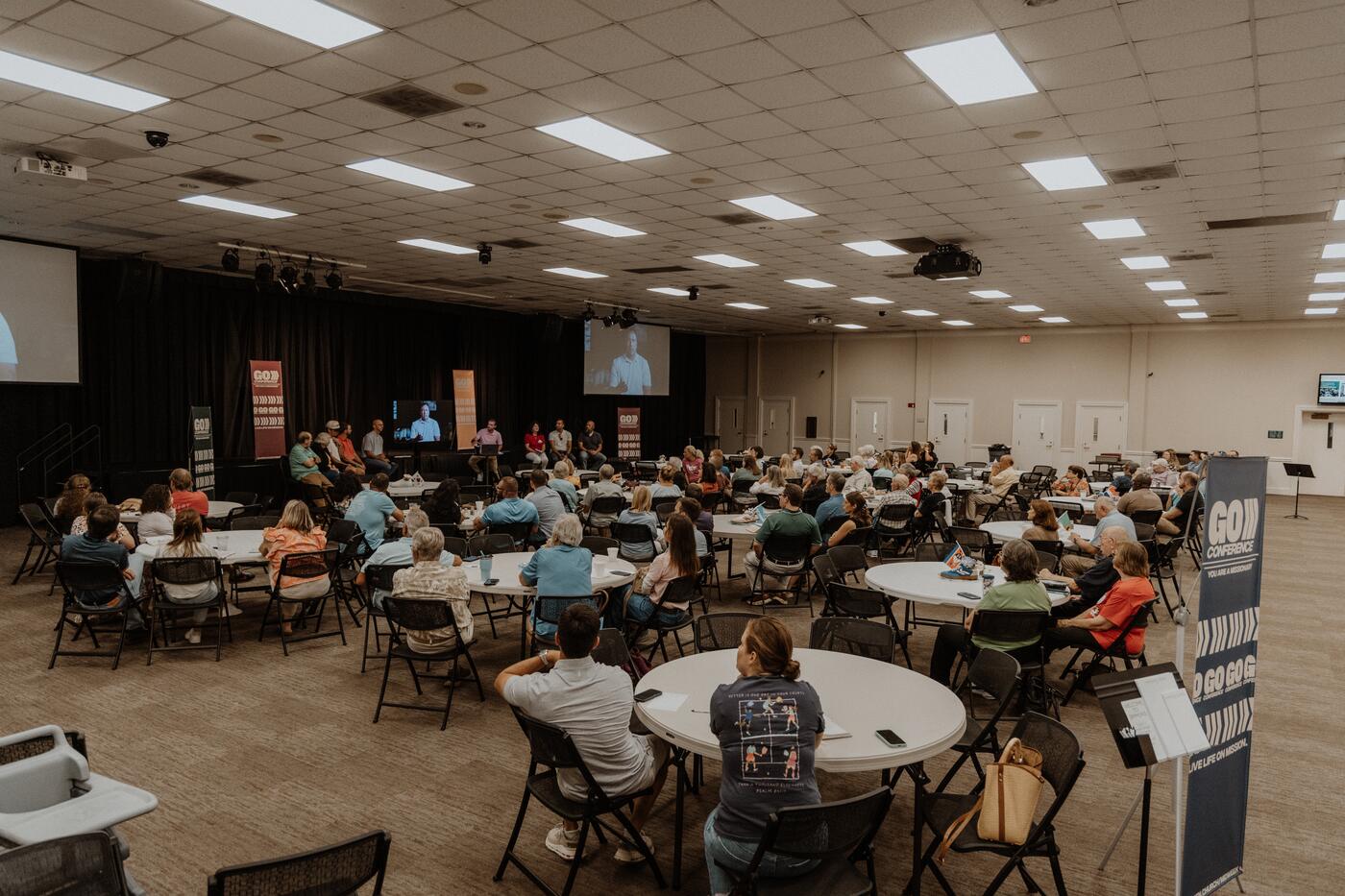 A hall full of round tables on a midweek night.