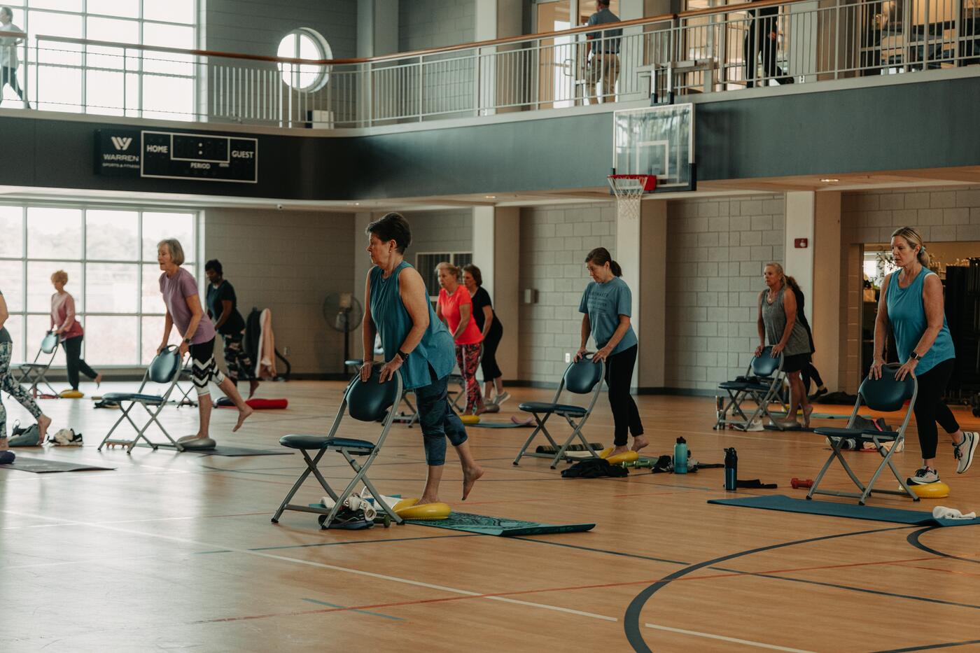 A row of members working through a step class.