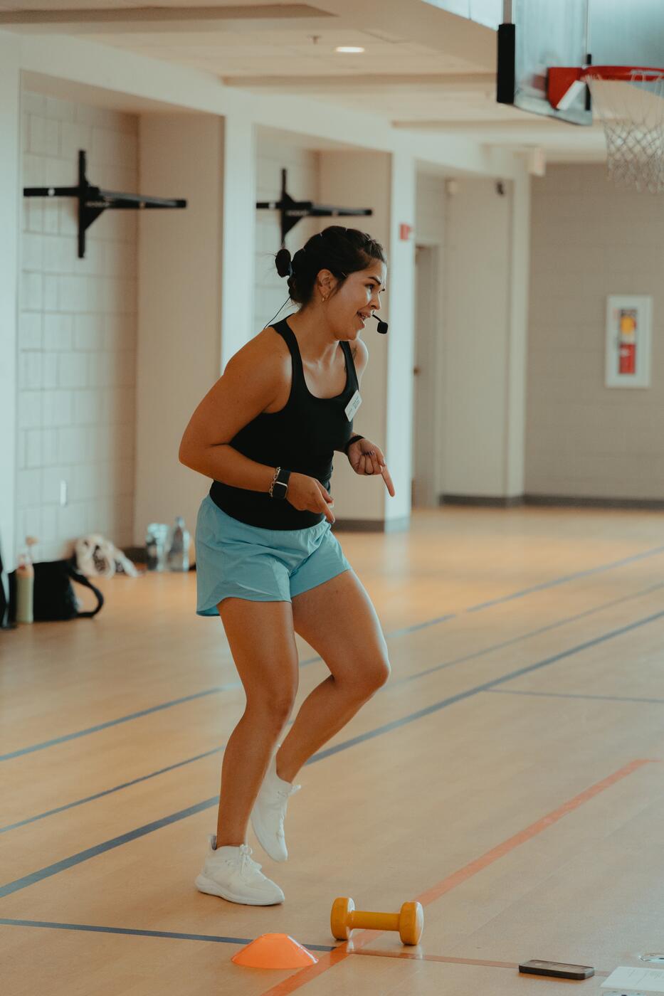 A member working through footwork drills on the gym floor.
