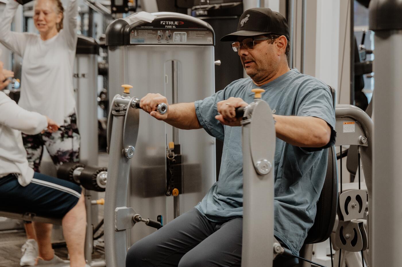 Working alongside a member at a machine.