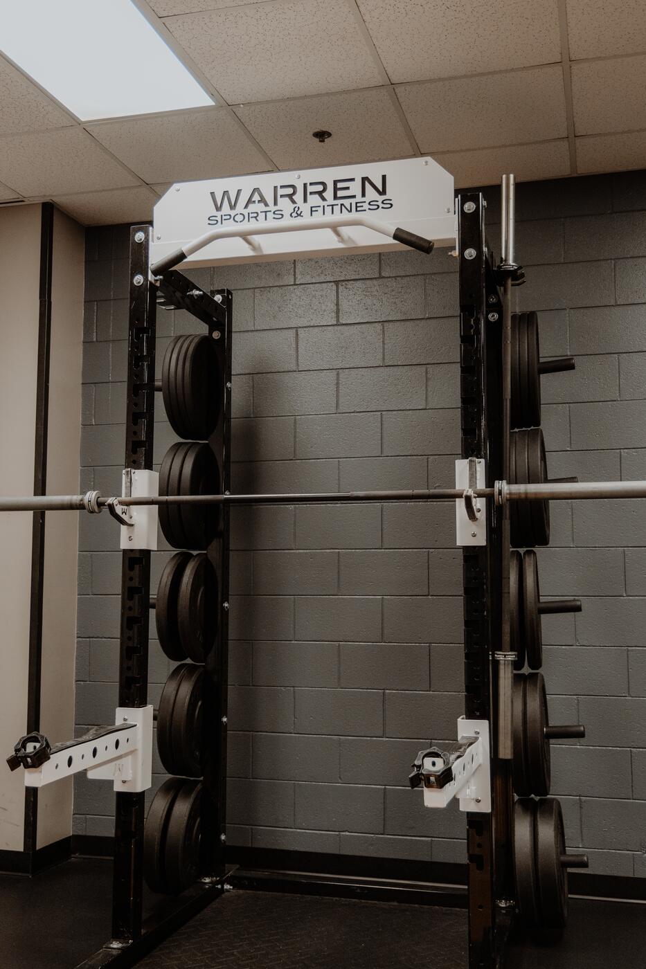A rack under the Warren Sports & Fitness sign.